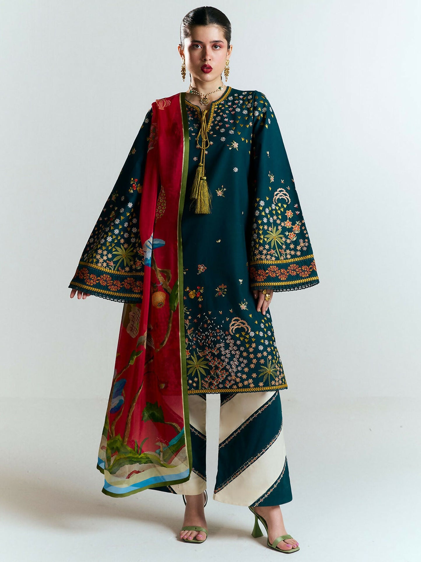 Deep teal embroidered cotton shirt with floral motifs, matching embroidered culottes with ivory trims, and digitally printed silk dupatta in vibrant reds and greens.