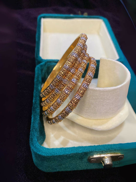 Noor Bilal gold plated bangles with elegant polished design.