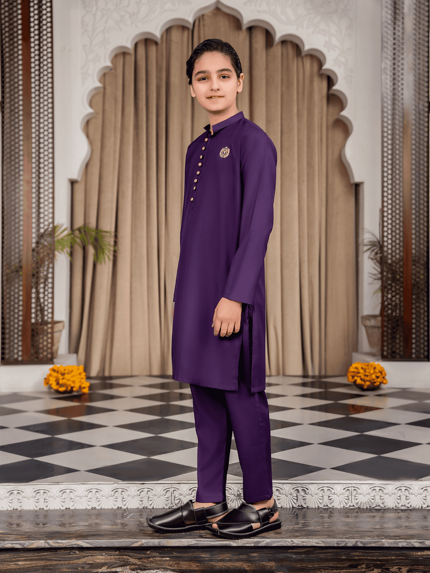 Boy wearing purple cotton kurta trouser suit with decorative buttons, embroidered chest motif, mandarin collar, full sleeves, and regular fit