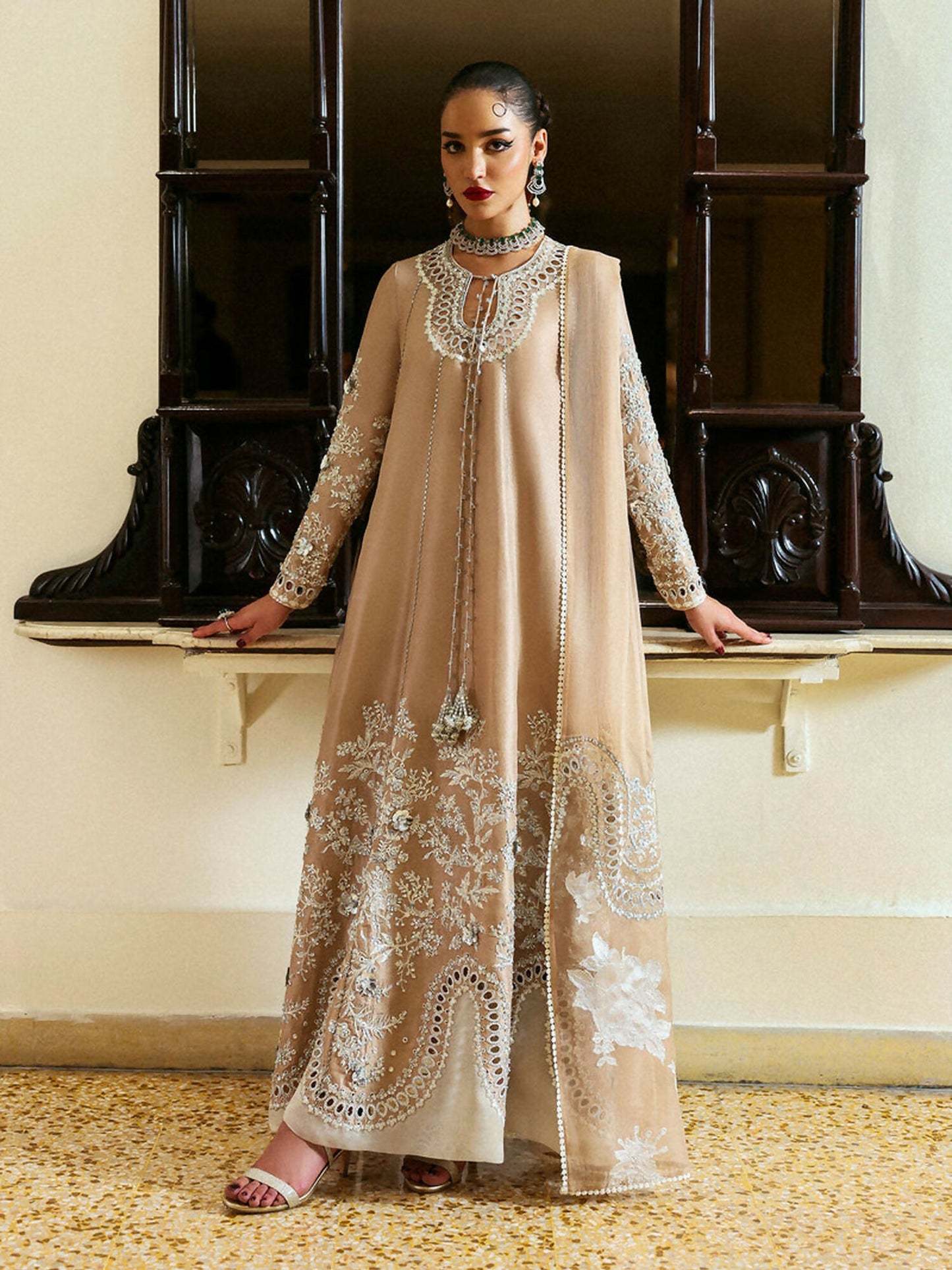 Unstitched 3-piece suit featuring raw silk embroidered shirt with silver embellishments and tassel detailing, organza dupatta with satin silk patchwork embroidery, and matching raw silk culottes.