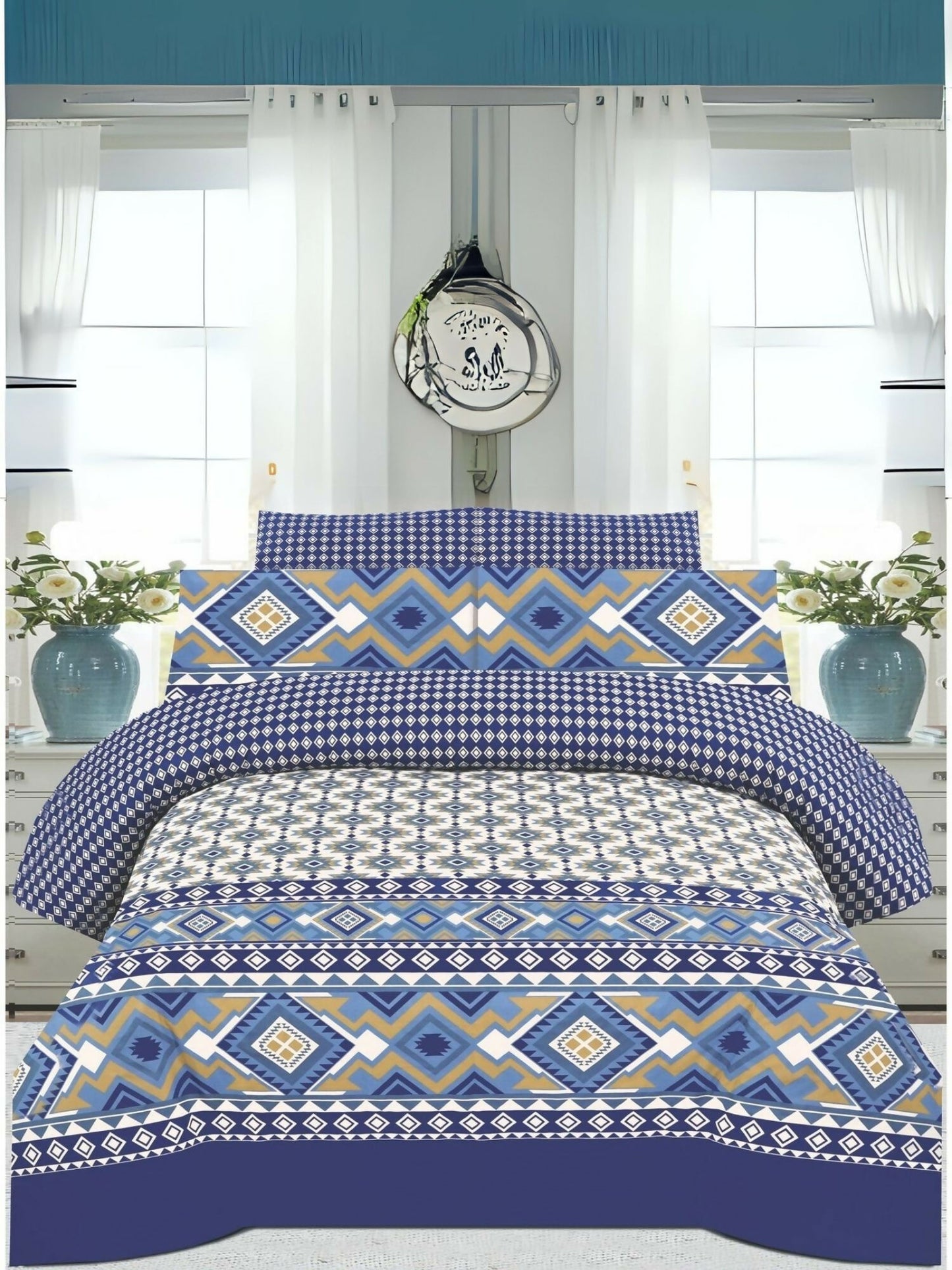 A king size bedsheet with geometric blue, white, and mustard pattern, styled with matching pillow covers on a neatly made bed.