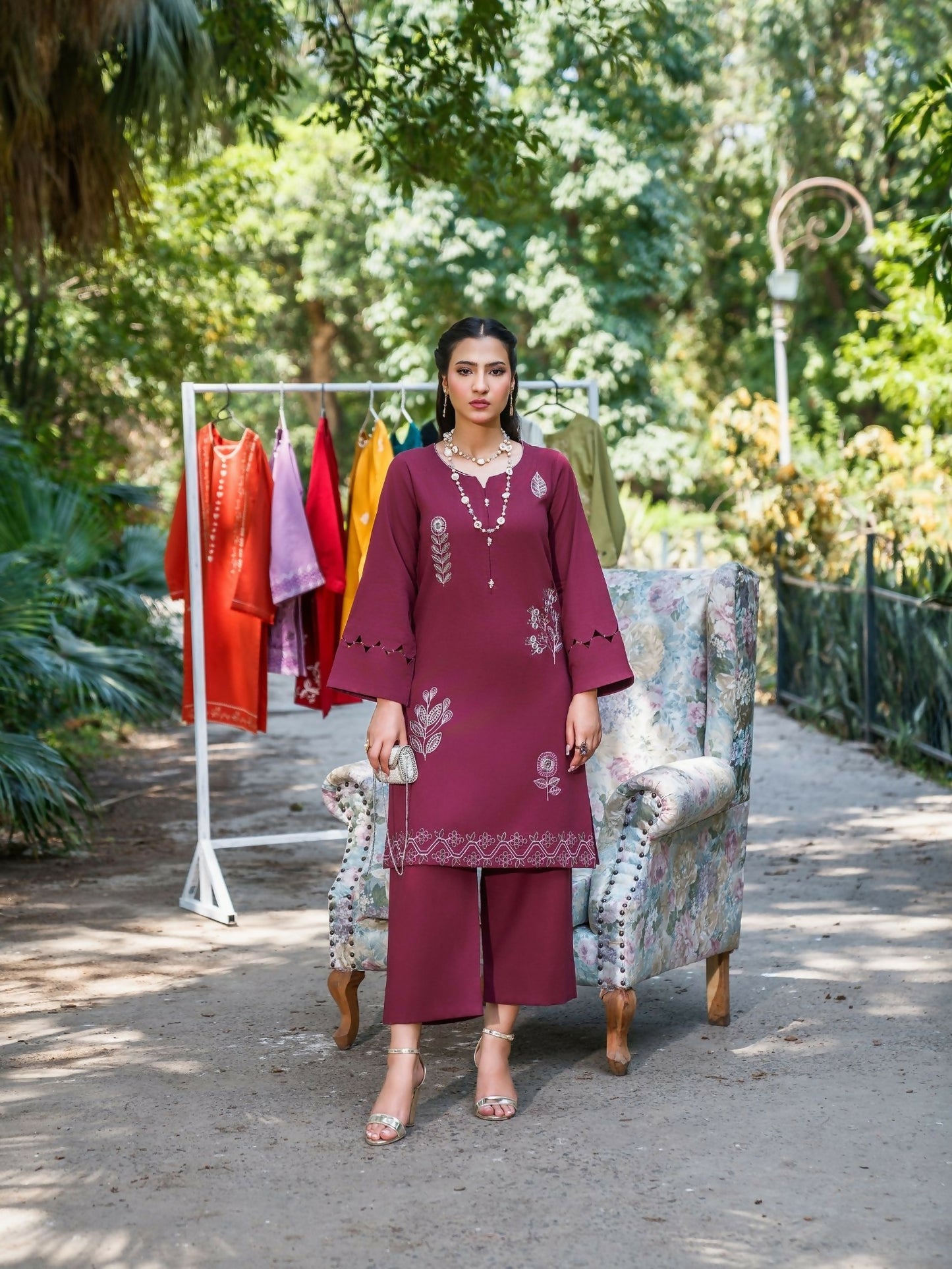 Rich wine stitched two-piece suit with embroidered front and sleeves, cutwork and scallop detailing, paired with straight trousers by Sehrish Kanwal.