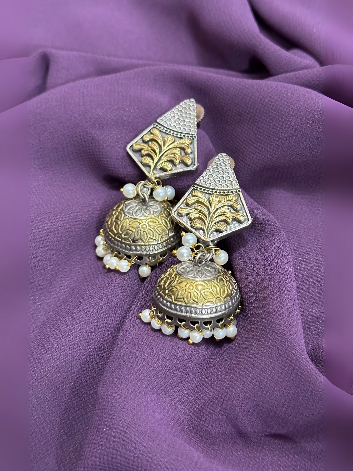 Glitter Jewellery oxidized jhumka earrings with engraved detailing and pearl bead hangings.