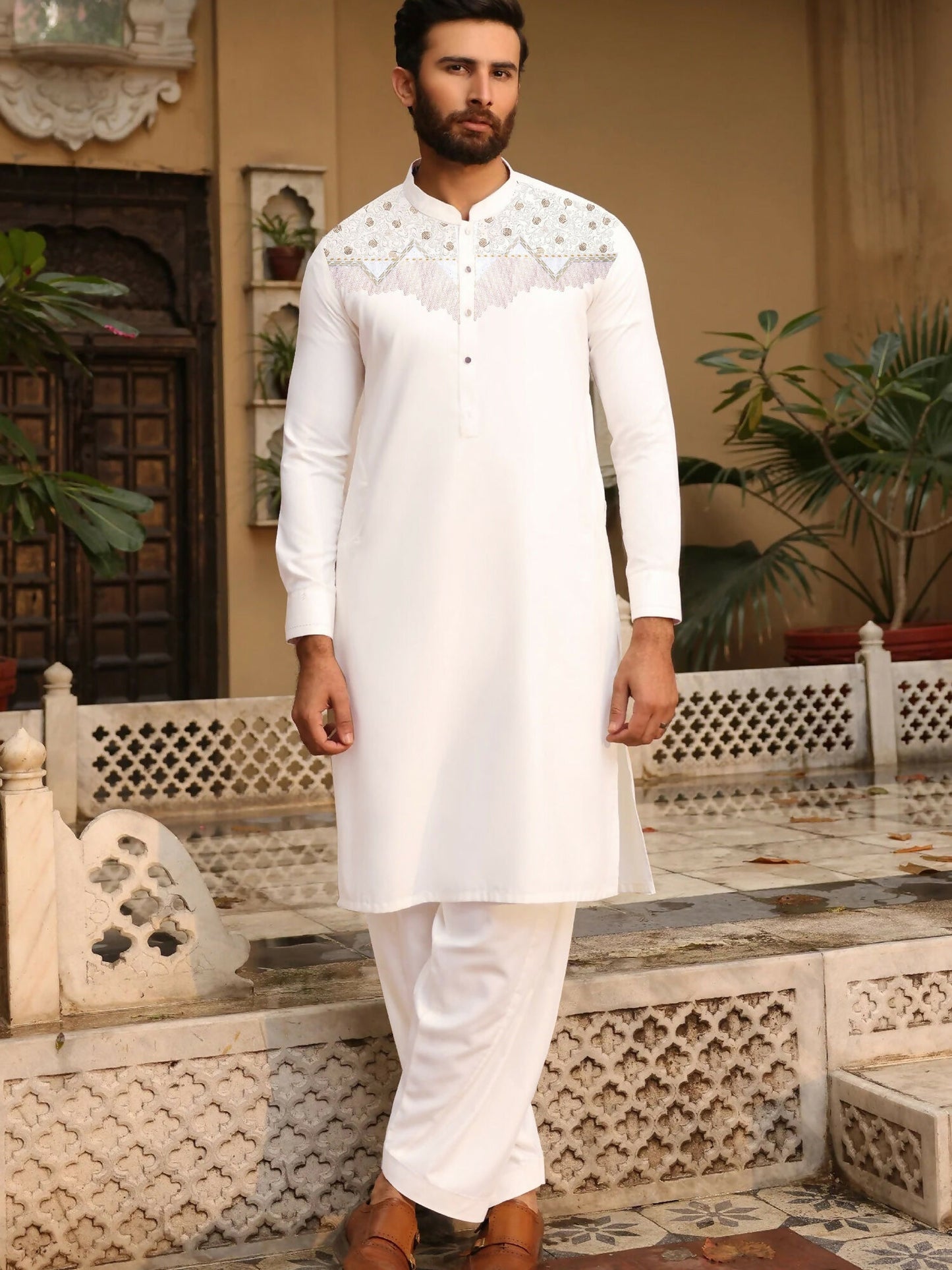 "Off-white unstitched men’s kameez shalwar by Fabrich, from the Monochrome Edit'25 collection, showcasing contrast-colored chest embroidery in a signature design on soft wash n wear fabric.