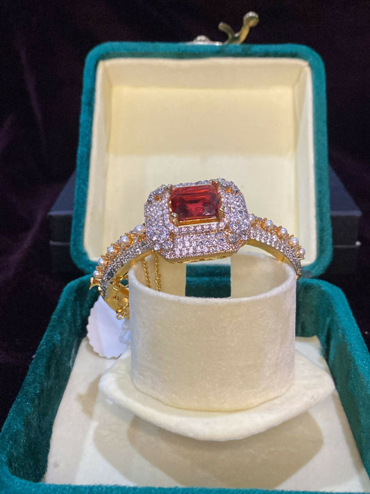 Noor Bilal openable gold plated bracelet in brass metal with red stone center, stylish and elegant jewellery piece.