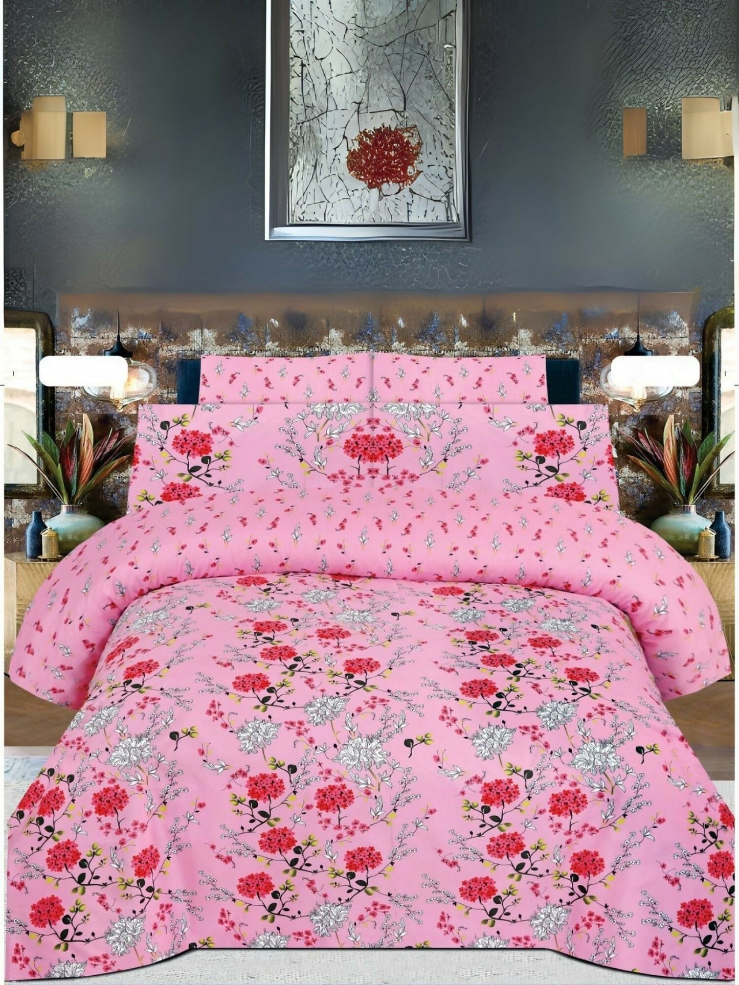 A pink bedsheet with red and white floral print, neatly spread on a bed with matching pillow covers.