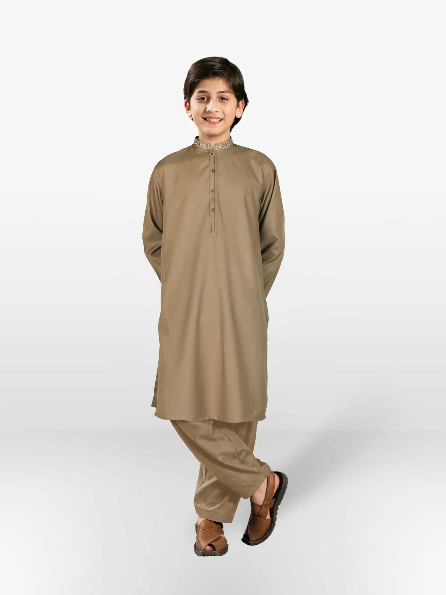 Boy wearing cotton kurta shalwar with subtle embroidery, mandarin collar, full sleeves, and regular fit