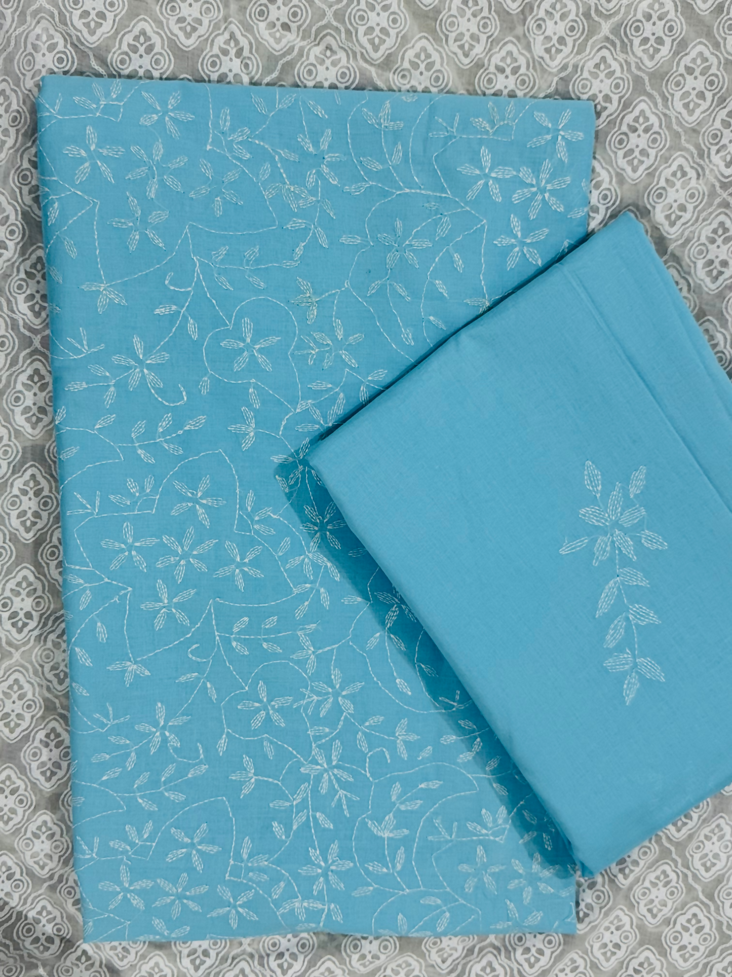 Fehm unstitched blue lawn 2-piece suit with all-over hand embroidery on the shirt and matching lawn dupatta featuring scattered hand embroidered boti motifs.
