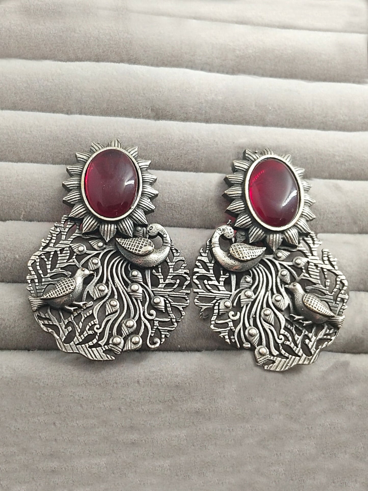 H&A Jewellery silver peacock motif earrings with red stone and sunburst design