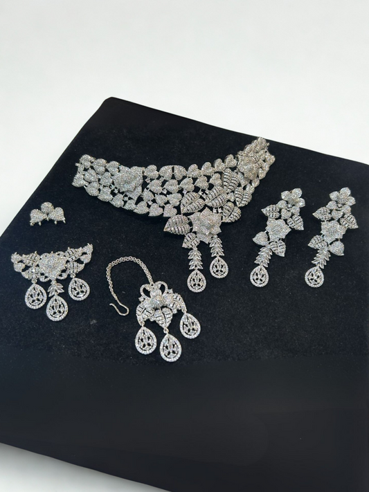 Noor Bilal one carat bridal jewellery set with choker necklace, matching long earrings, tikka and jhoomar, embellished with high-shine stones in floral and leaf motifs