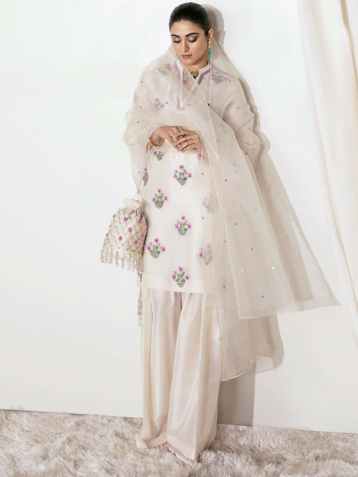 Hussain Rehar ivory raw silk hand-embellished shirt with matching embellished shalwar and sequin-sprayed organza dupatta.