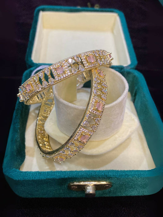 Noor Bilal Bangles set with intricate designs featuring pink stones at the center, elegant jewellery for women.