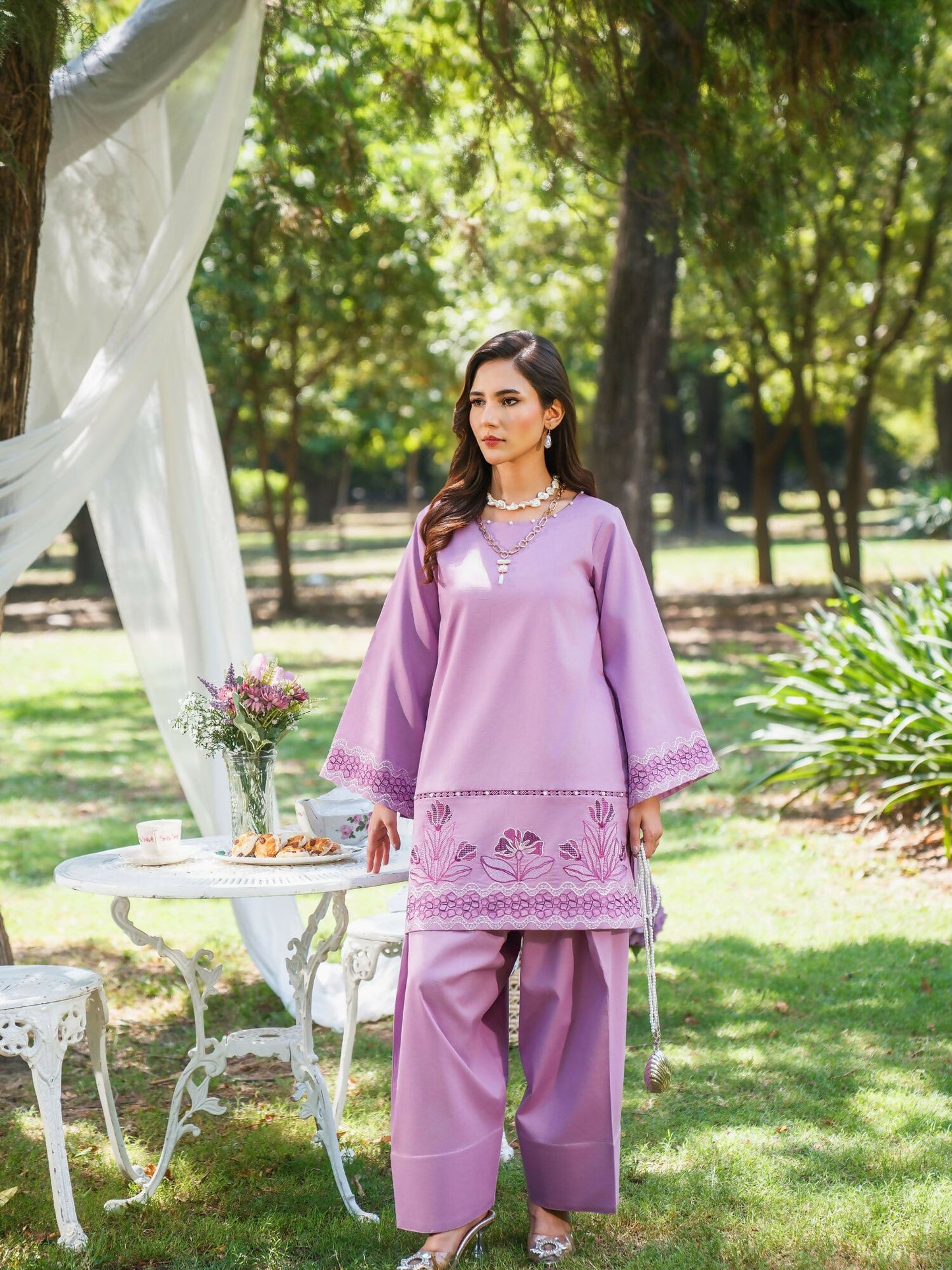 Lilac stitched two-piece suit with embroidered front and sleeves, lace details, pearl embellishments, paired with farshi shalwar by Sehrish Kanwal.