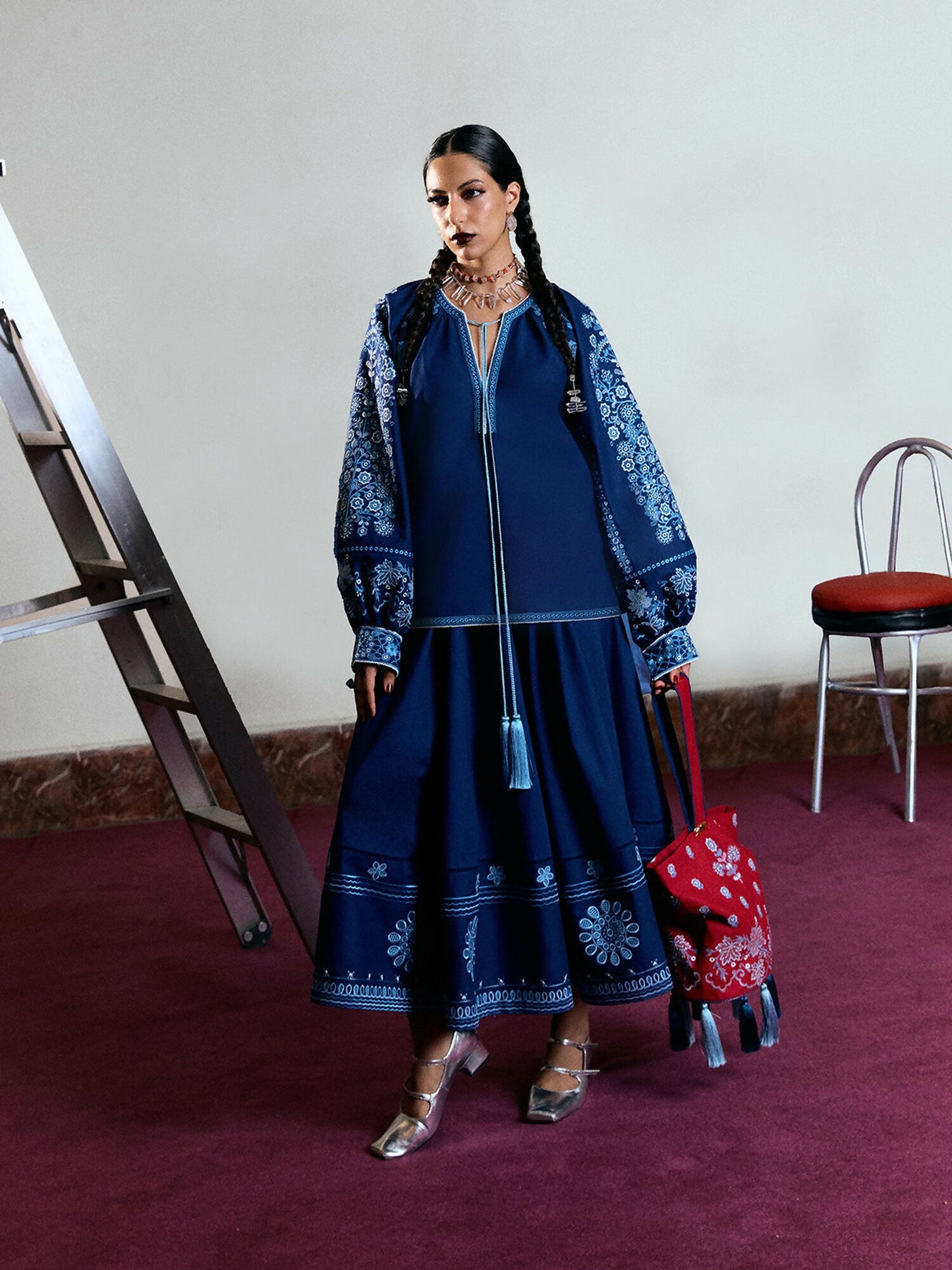 Navy blue cotton short shirt with monochrome traditional embroidery, boring, and tassels, balloon sleeves, and matching embroidered cotton skirt.