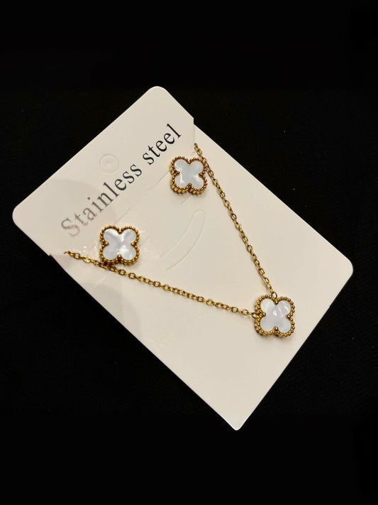 Noor Bilal clover pendant necklace with matching stud earrings in gold-tone stainless steel with white clover motifs