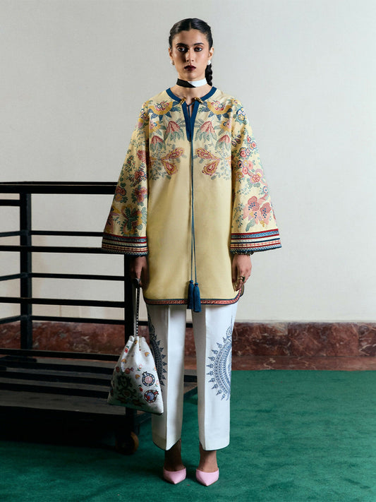 Light yellow cotton short shirt with multicolor floral embroidery and tassels, bell sleeves, ivory cotton culottes with monochrome embroidery, and digitally printed chiffon dupatta.
