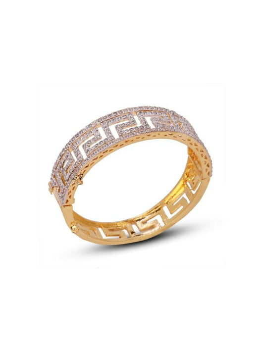 Noor Bilal gold plated brass bangle with geometric cutwork and stone detailing.