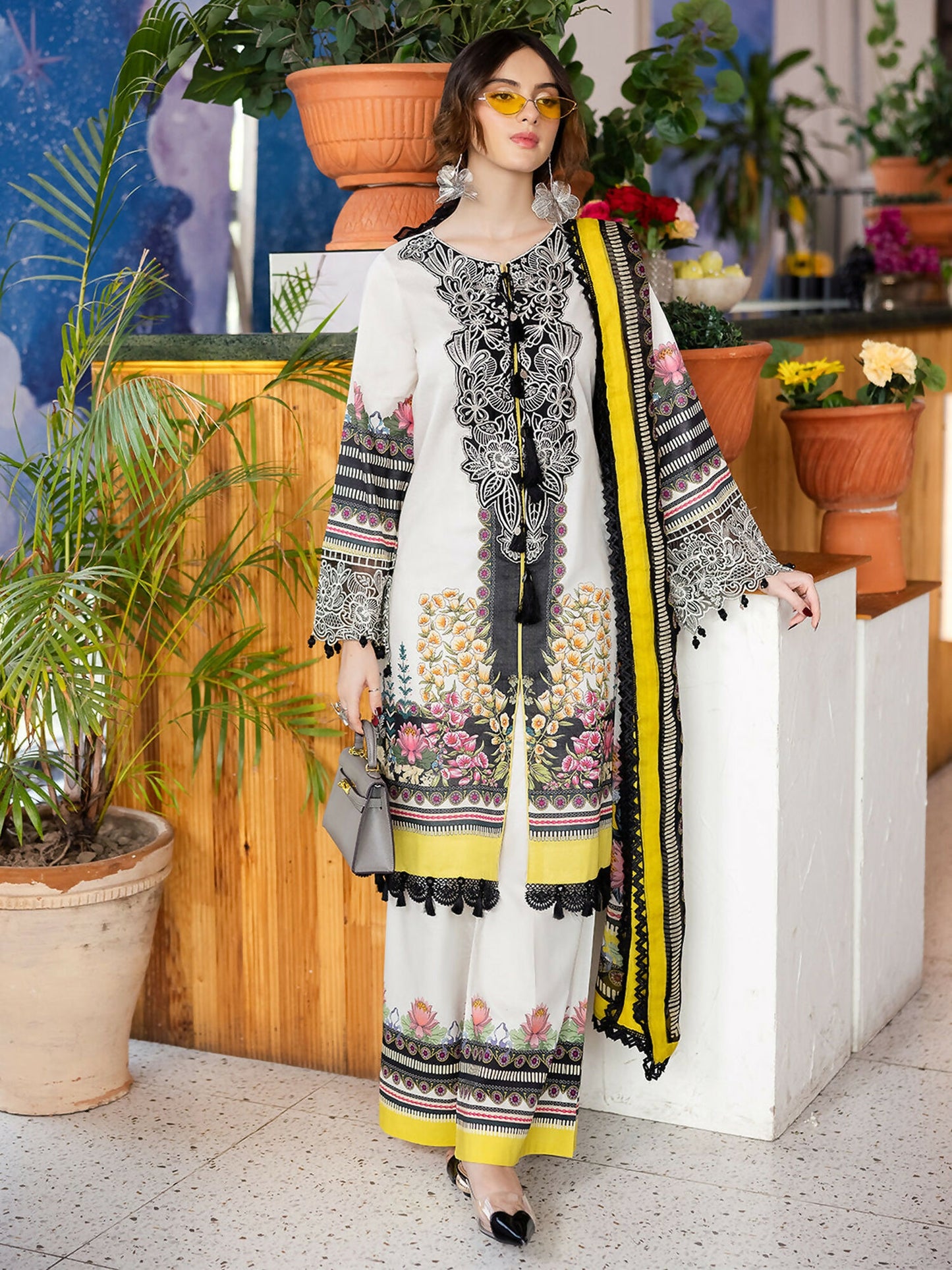 Unstitched 3-piece lawn suit with embroidered neckline, embroidered borders, printed lawn shirt, printed chiffon dupatta, and printed trouser.