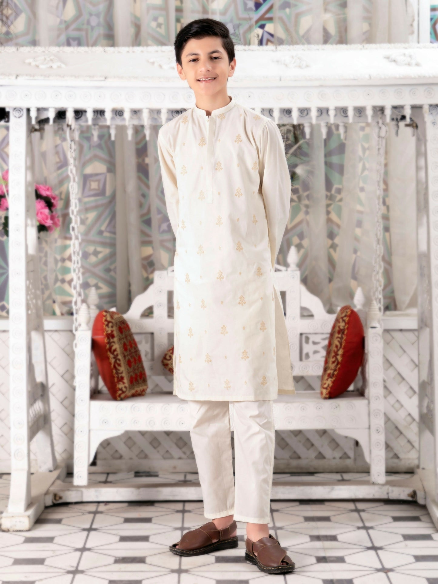 Boy wearing cotton kurta trouser set with all-over embroidery, mandarin collar, full sleeves, and regular fit