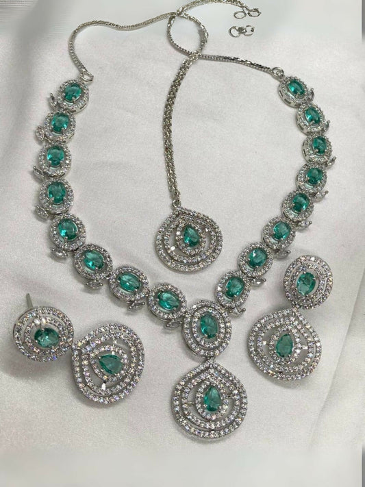 Noor Bilal one carat American diamond necklace set with matching earrings and bindi, featuring silver-toned stones and light blue aqua center stones.