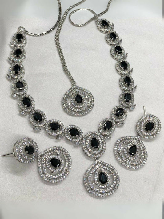 Noor Bilal one carat American diamond necklace set with matching earrings and bindi, featuring silver-toned stones and bold black center stones.