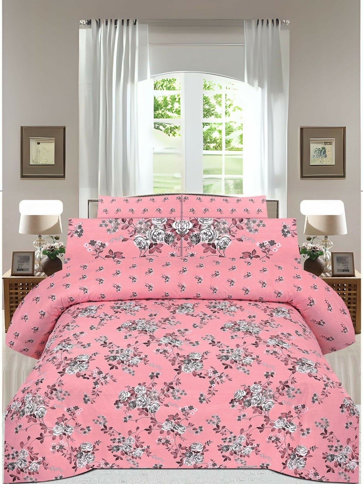 A pink king size bedsheet with soft floral print, paired with matching pillow covers on a neatly arranged bed.