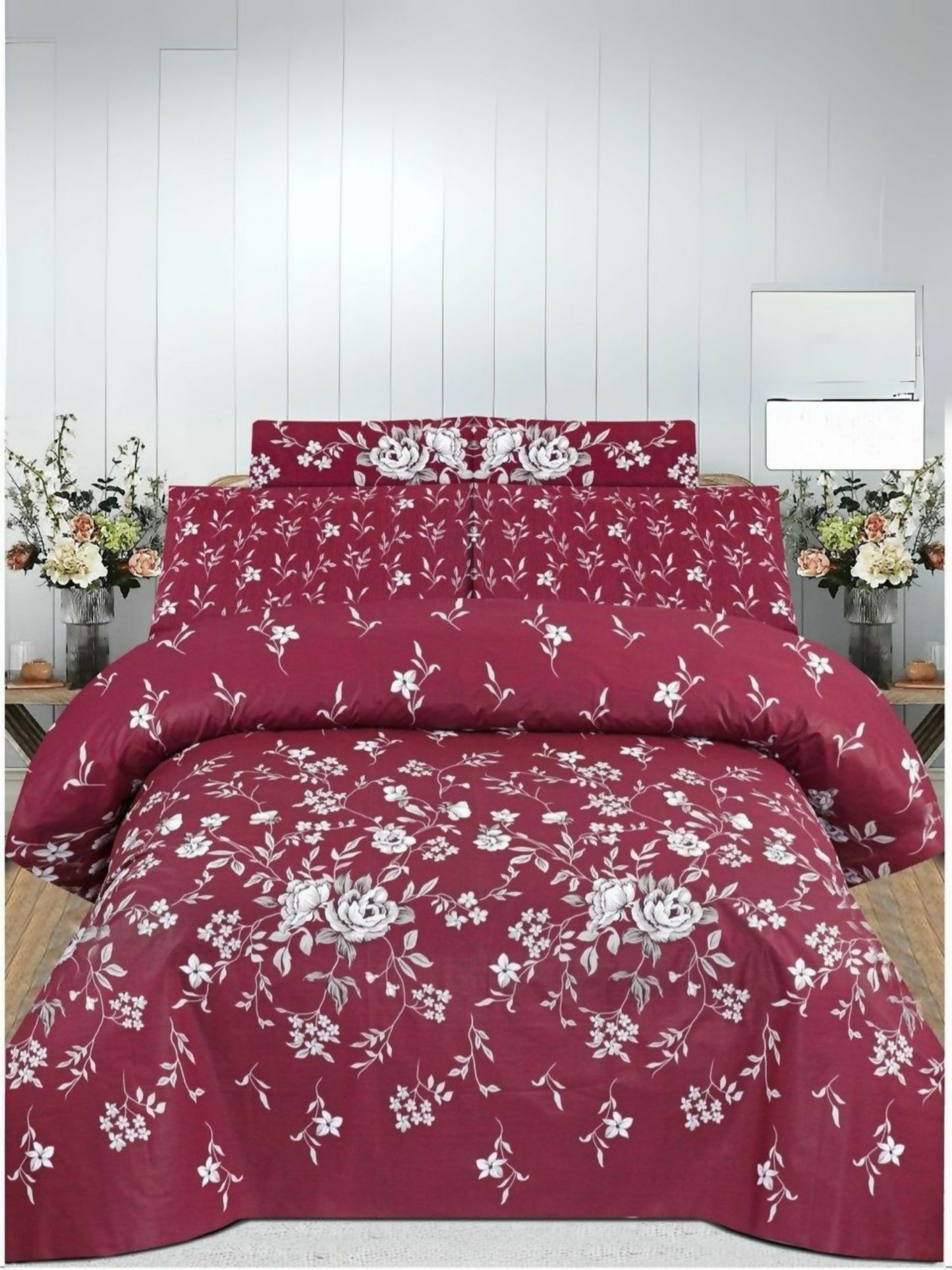 Maroon comforter set with white floral pattern arranged on a double bed, includes matching bedsheet and pillow covers.