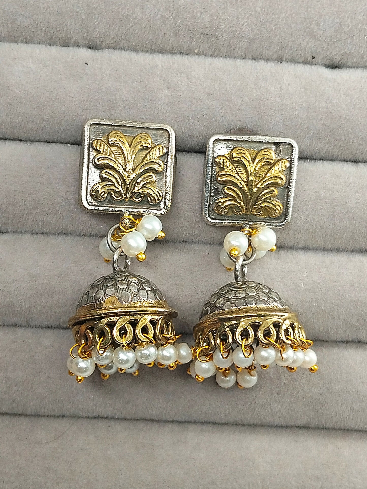 H&A Jewellery dome-shaped jhumka earrings with gold-toned floral studs and hanging pearl bead drops.