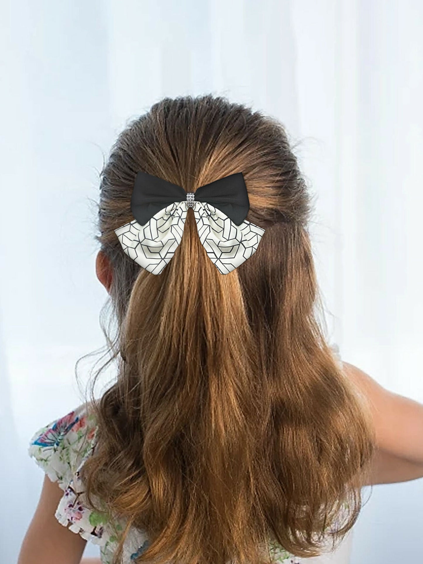 Girl wearing Glitter Jewellery printed hair bow with geometric detailing and rhinestone center