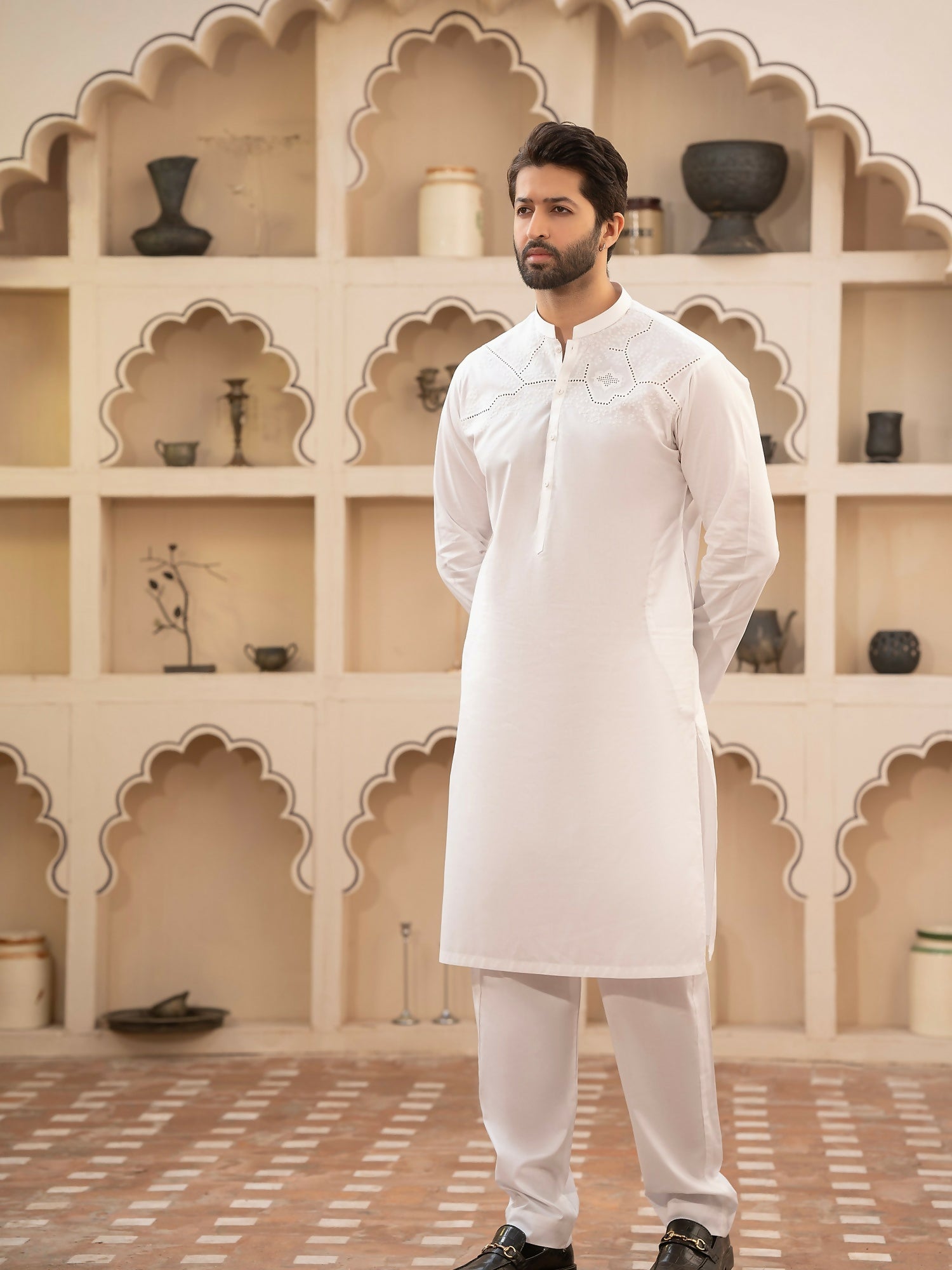 Men's unstitched off-white kameez shalwar from the Miraas Collection by Fabrich, made with luxury soft fine 100% cotton, featuring cotton-thread cutwork chest embroidery with signature pattern and design, finished with designer buttons and branded details.