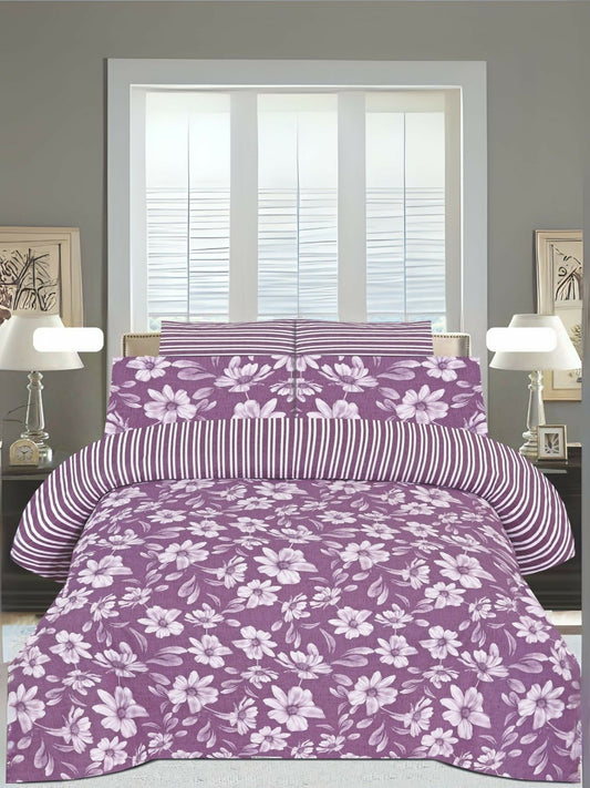 A pink king size bedsheet with white floral design, neatly spread on a bed with matching pillow covers.