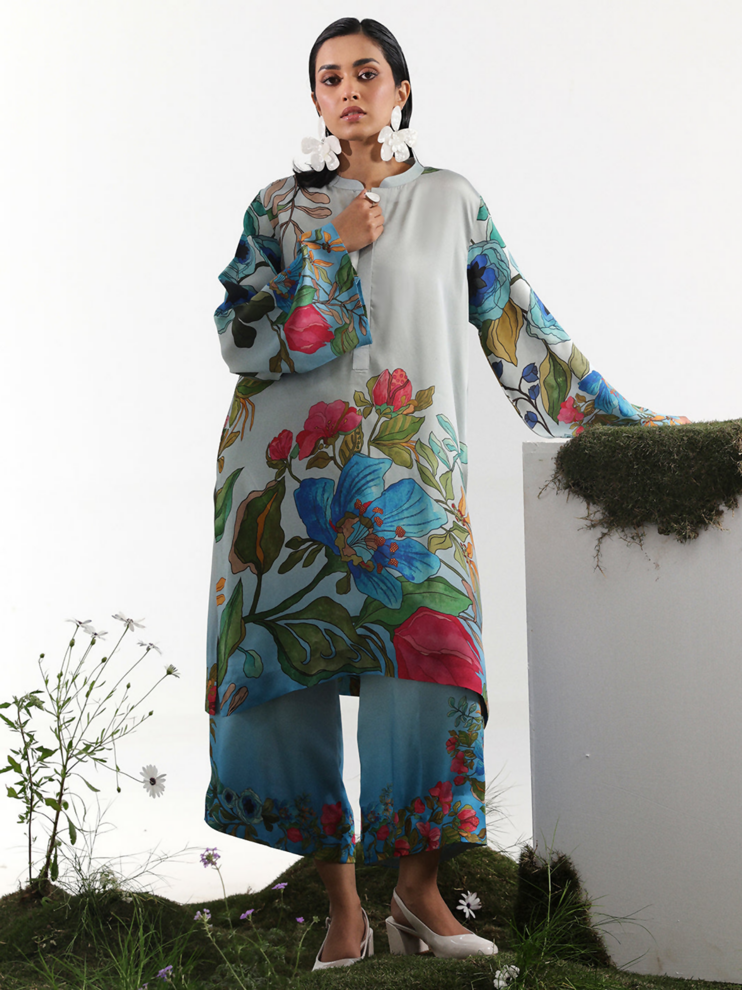 Model wearing a powder blue digital printed silk co-ord set with vibrant oversized floral patterns and full-length sleeves