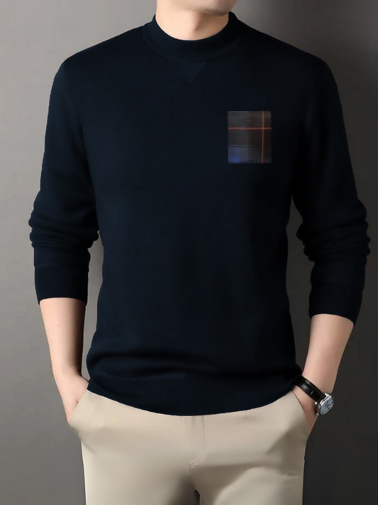 Man wearing a navy cotton fleece sweatshirt with a contrast front pocket, crew neck, ribbed cuffs, and ribbed bottom.