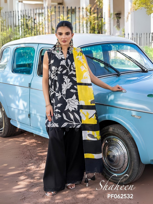 Unstitched 3-piece suit with black lawn shirt featuring white floral and leafy print, yellow dobby voil dupatta with black lines and white patterns, and plain black dyed cotton trouser, perfect for bold summer wear.