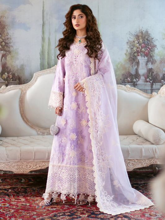 Unstitched 3-piece embroidered suit with cotton net shirt, embroidered back and sleeves, 3D floral embellishments, printed lawn slip, embroidered dupatta, and dyed trouser.