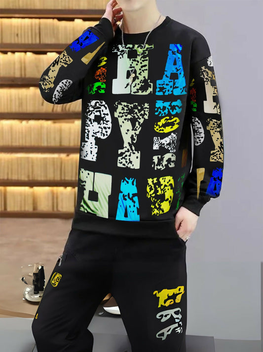 Man wearing a black tracksuit with bold multicolored “HAPPY” text on the sweatshirt and abstract prints on the jogger pants.