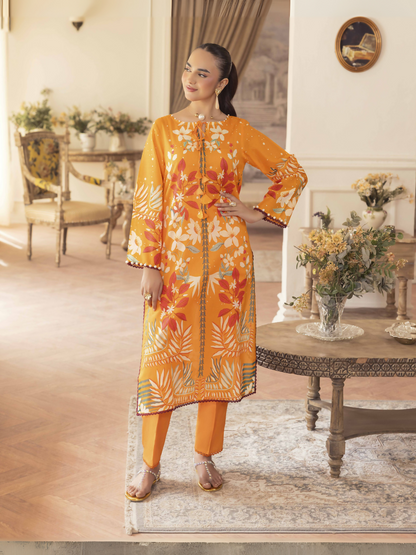 Woman wearing an orange 2 piece unstitched lawn suit with colorful floral print and dyed cotton trouser.