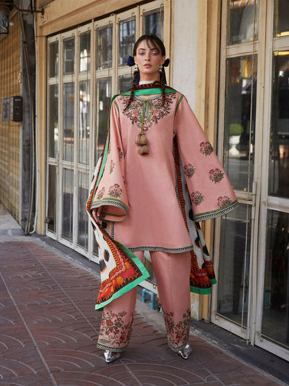 Woman wearing peach pink embroidered cotton straight shirt with flared sleeves, matching embroidered cotton plazzo pants, and printed silk dupatta, 3-piece unstitched suit.