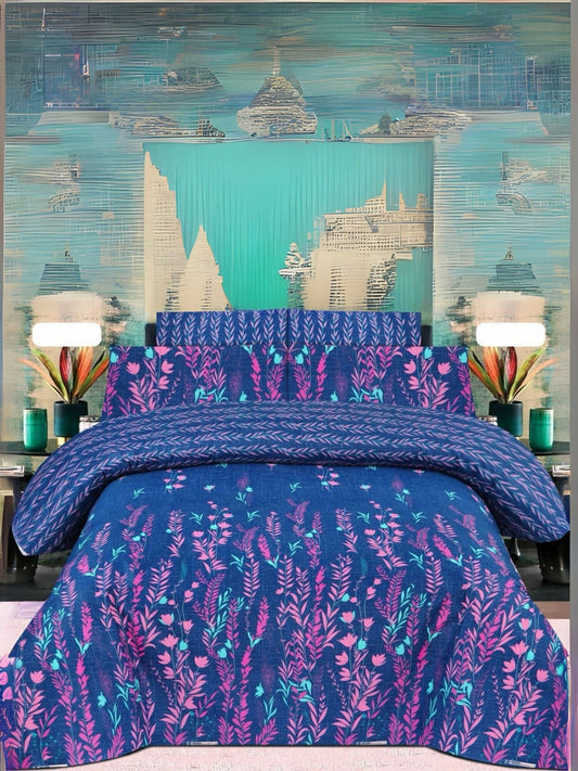 Blue bedsheet with pink and cyan leaf design, neatly spread on a bed with matching pillow covers.
