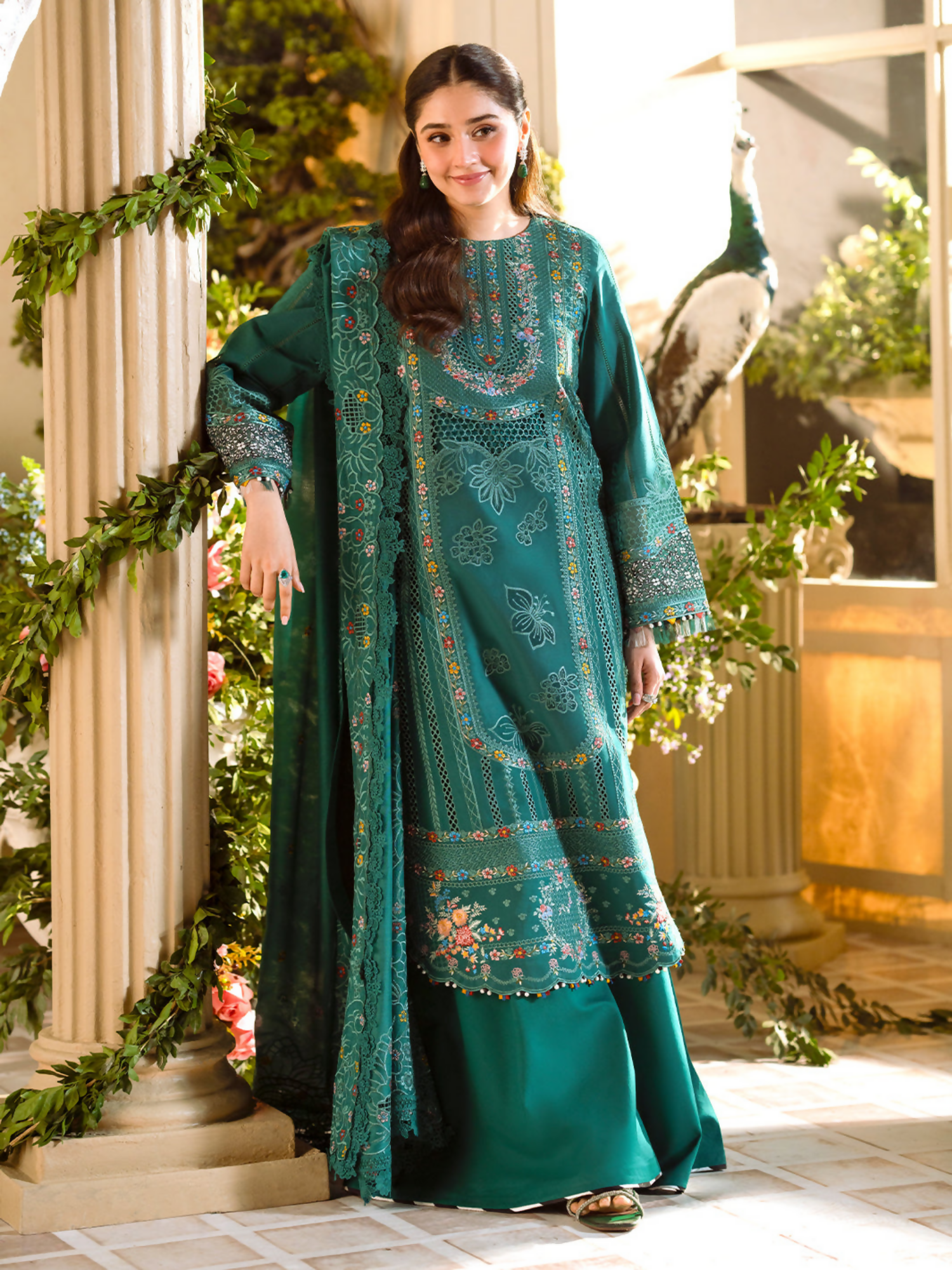 Classic borer and laser-embroidered lawn suit with front and sleeve motifs, embroidered cotton mix dupatta, and dyed cotton trouser for a graceful finish.