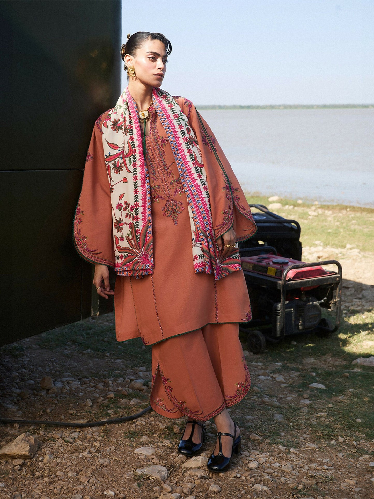 Jugnu by Hussain Rehar terracotta 3-piece Karandi shirt and trouser with multicolored embroidery, styled with cream printed wool shawl