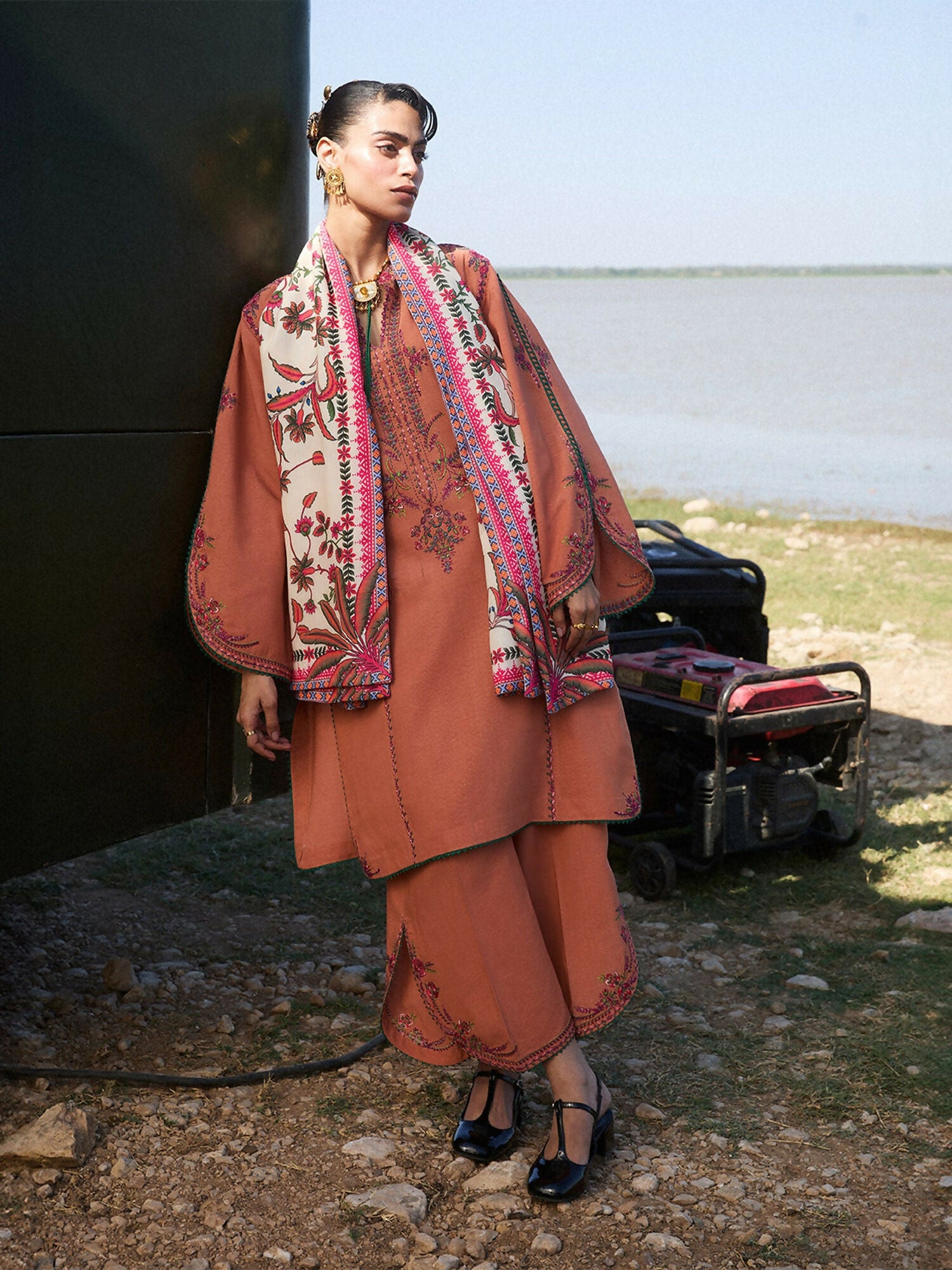 Jugnu by Hussain Rehar terracotta 3-piece Karandi shirt and trouser with multicolored embroidery, styled with cream printed wool shawl