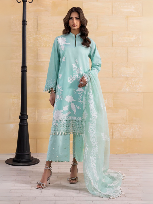 Unstitched 3-piece suit by Sana Safinaz with embroidered chambray shirt, organza borders and patti, embroidered woven net dupatta with organza pallu, and dyed cotton pants.