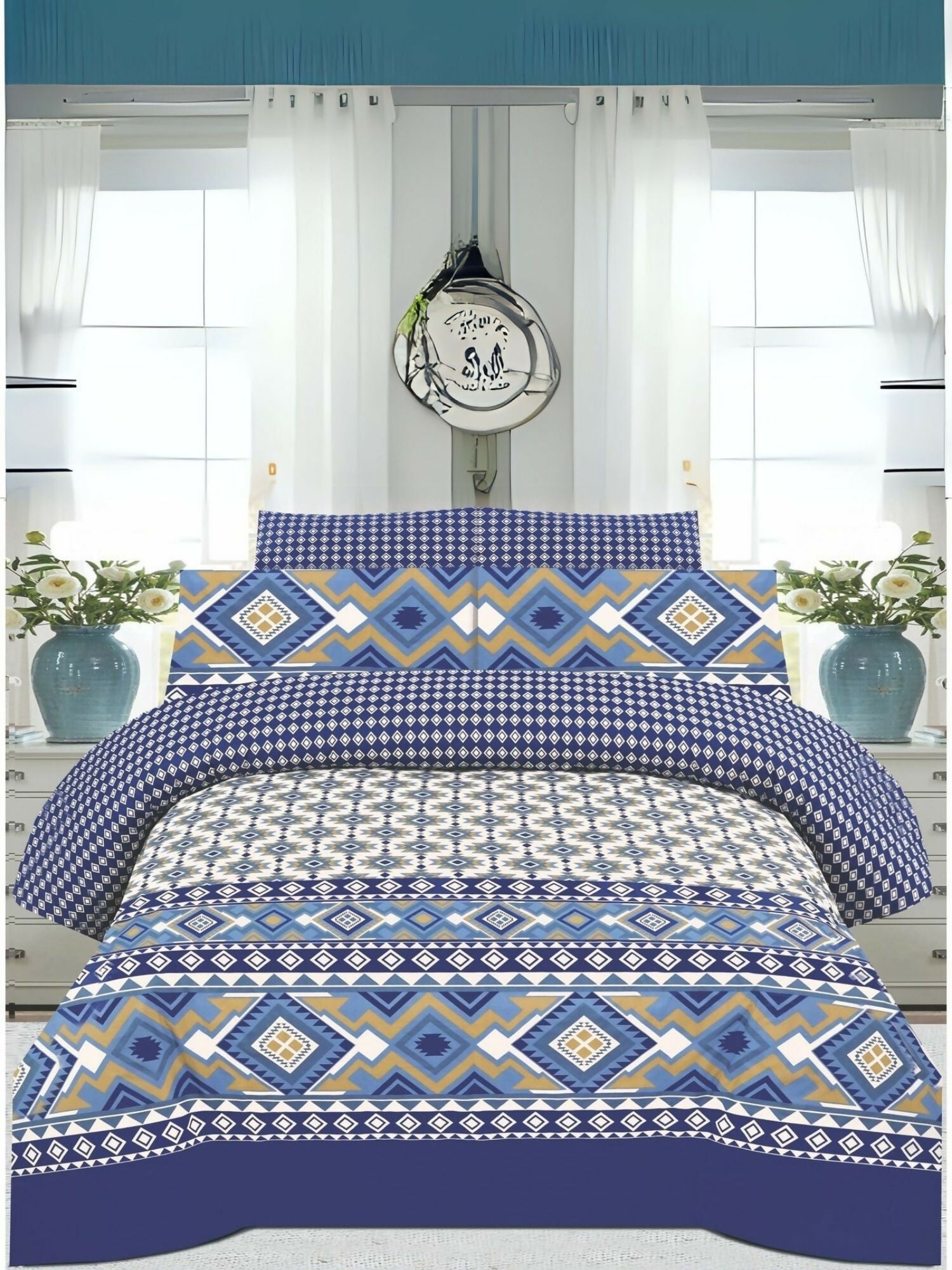 A king size bedsheet with geometric blue, white, and mustard pattern, styled with matching pillow covers on a neatly made bed.