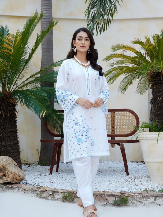 Girl wearing Trends Forever white lawn cotton embroidered kurta with sky-blue floral motifs, scalloped hem, and matching shalwar; stitched 2-piece suit.