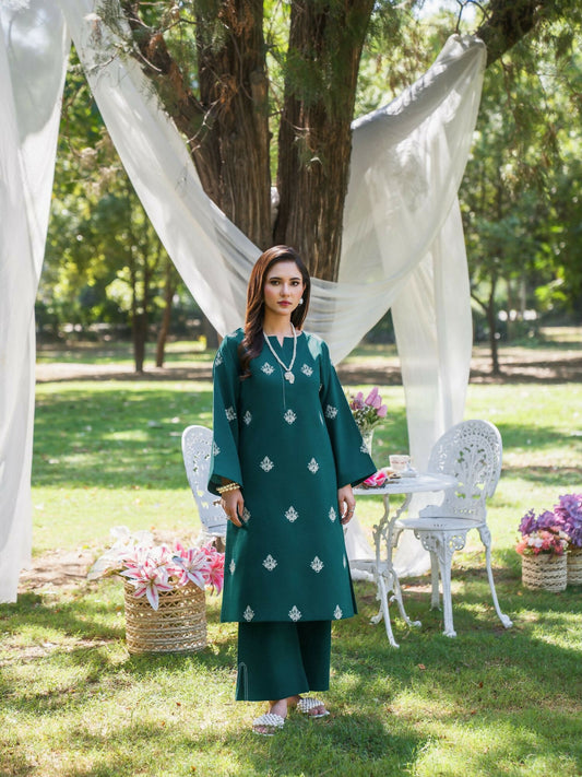 Teal green stitched two-piece suit with embroidered front and sleeves, round neckline with V-placket and running stitch, paired with straight trousers with side slit by Sehrish Kanwal.