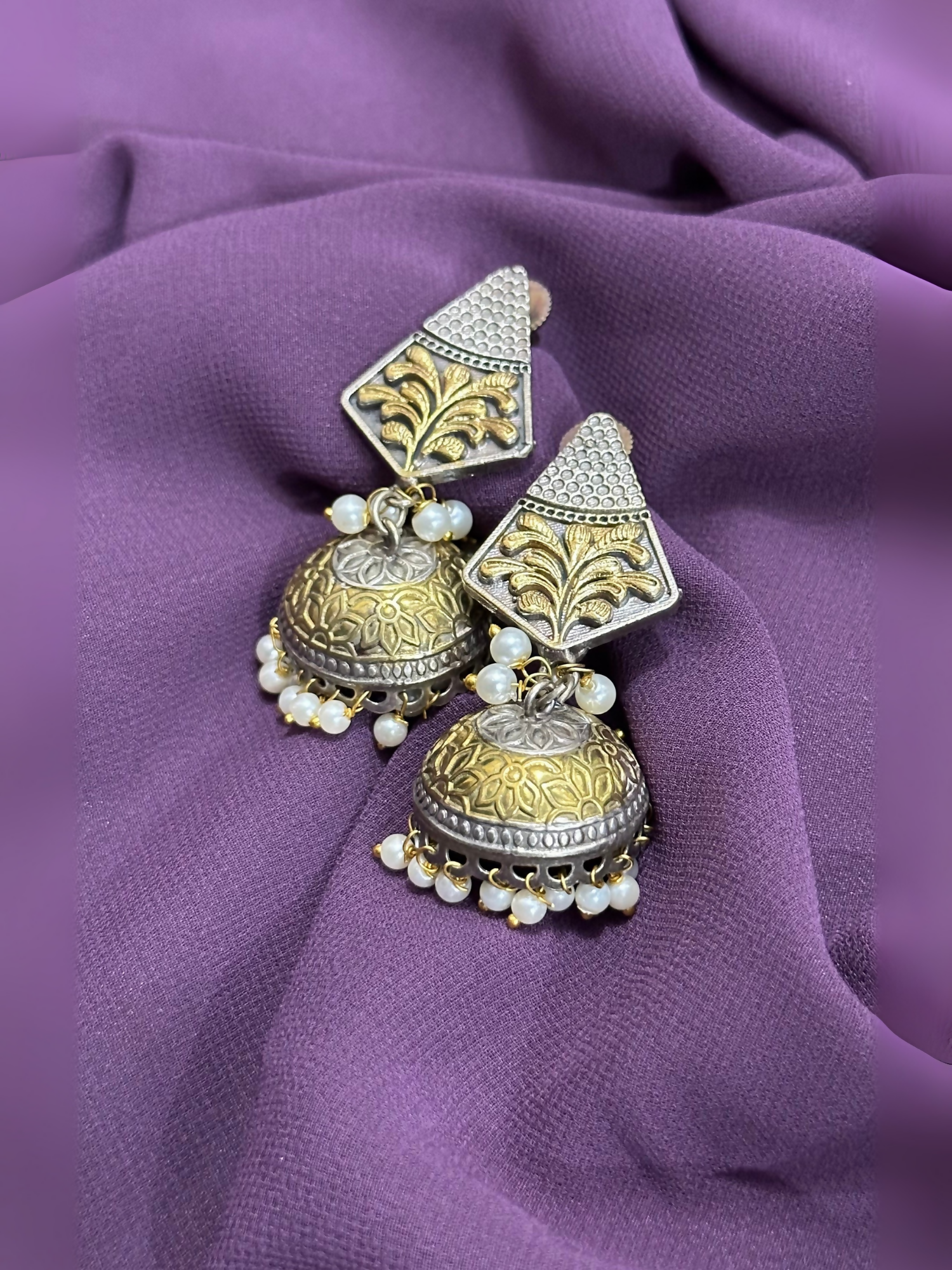 Glitter Jewellery oxidized jhumka earrings with engraved detailing and pearl bead hangings.