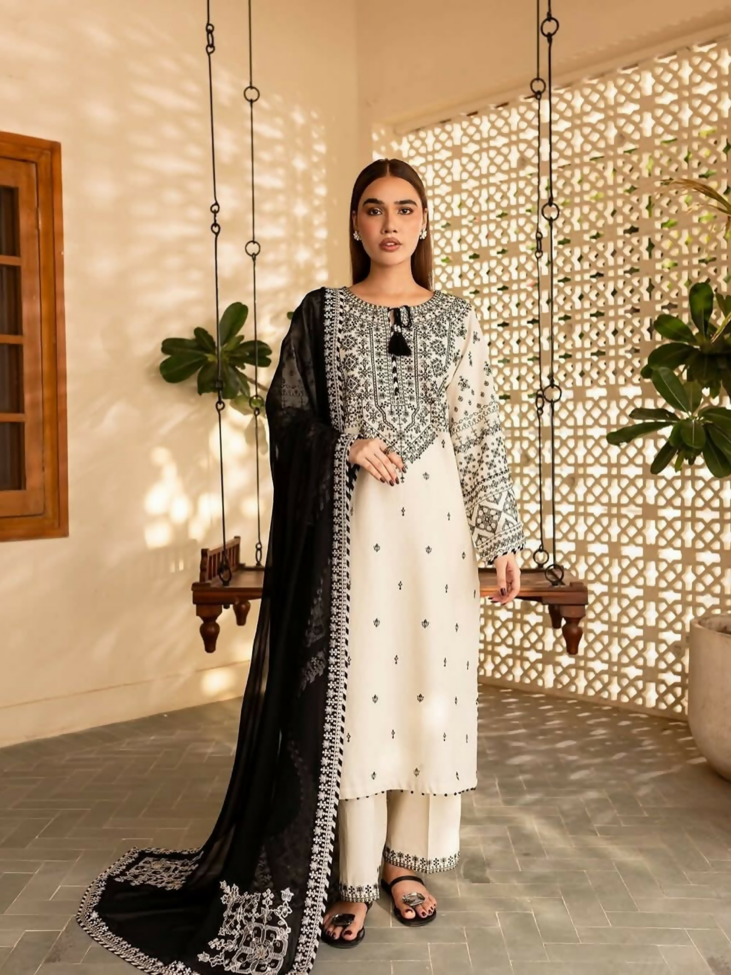 Tehzeeb Libas stitched 3-piece suit with embroidered ivory lawn shirt and trousers, paired with black chiffon dupatta featuring detailed threadwork.