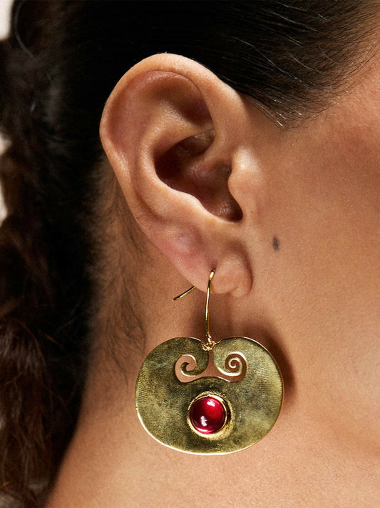 Jugnu by Hussain Rehar Crimson Swirl circular earrings with intricate swirl design, deep red center stone, and gold-tone finish, elegant statement accessory.