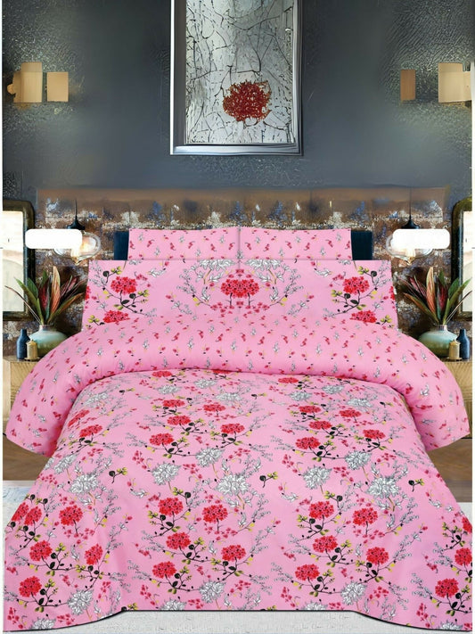 A pink bedsheet with red and white floral print, neatly spread on a bed with matching pillow covers.